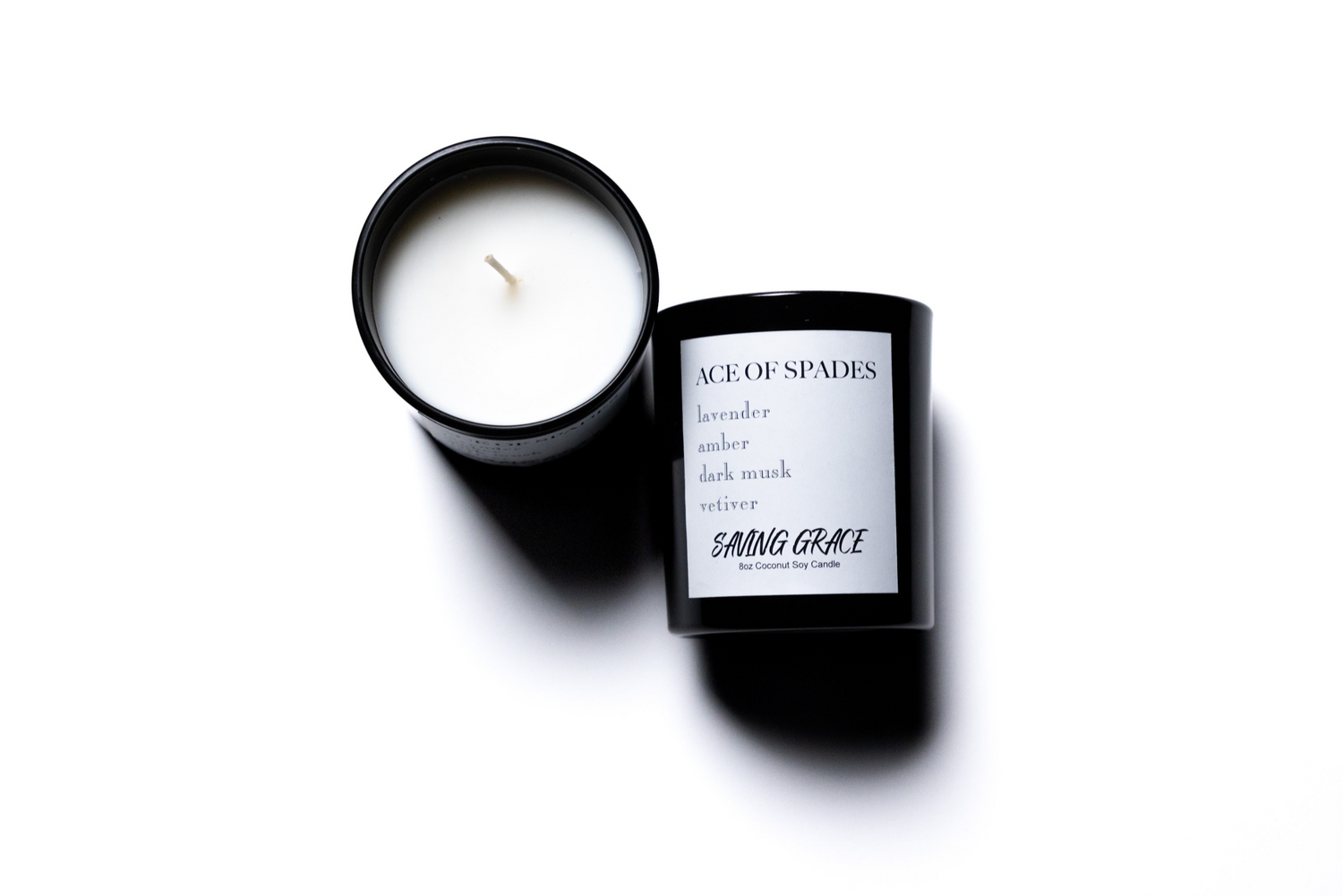 Hand-poured Ace of Spades candle with black glass container, unlit.