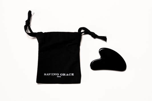 Black obsidian gua sha tool for skincare rituals, massage, and enhancing product absorption