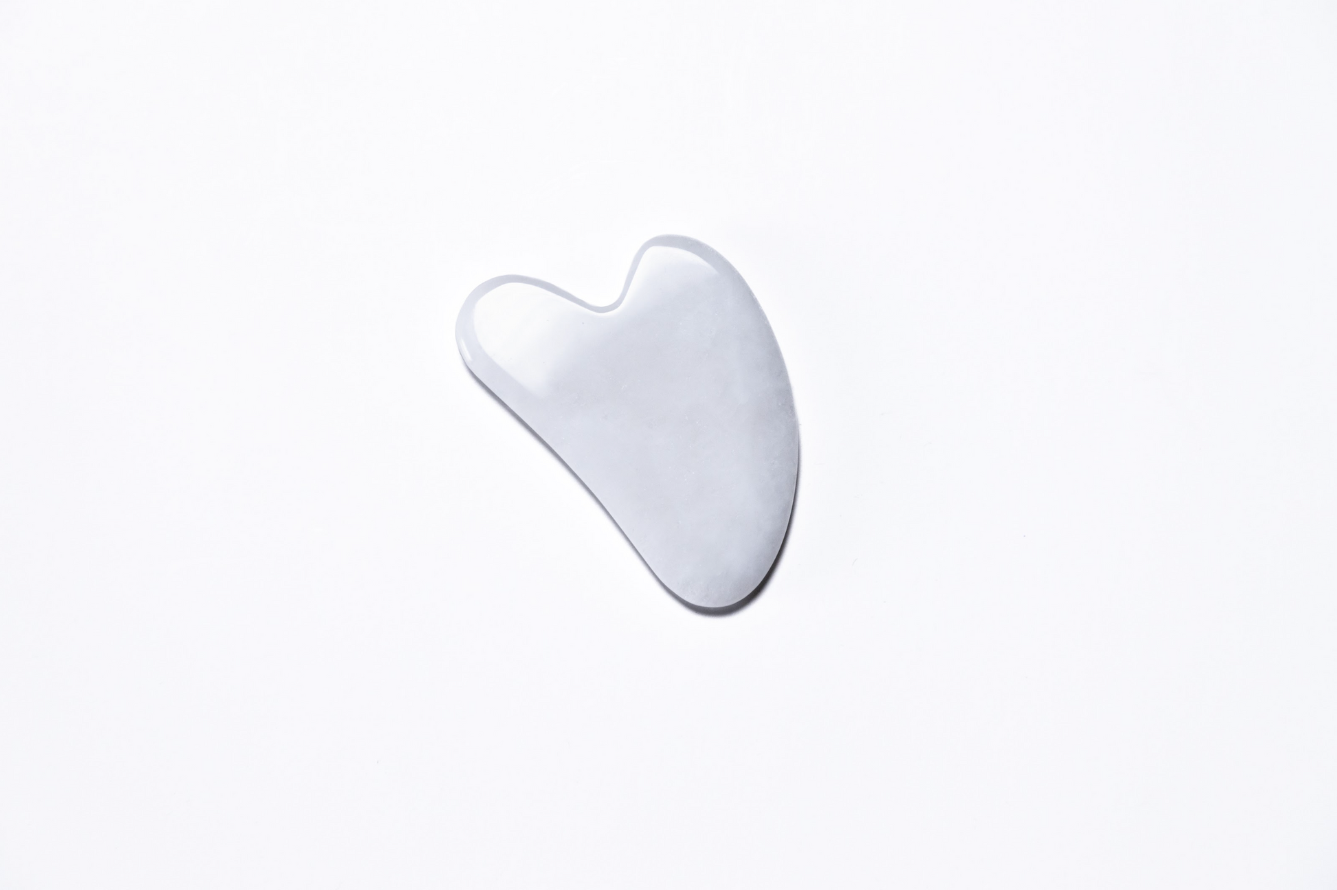 Handcrafted white jade gua sha for sculpting, toning, and skincare rituals